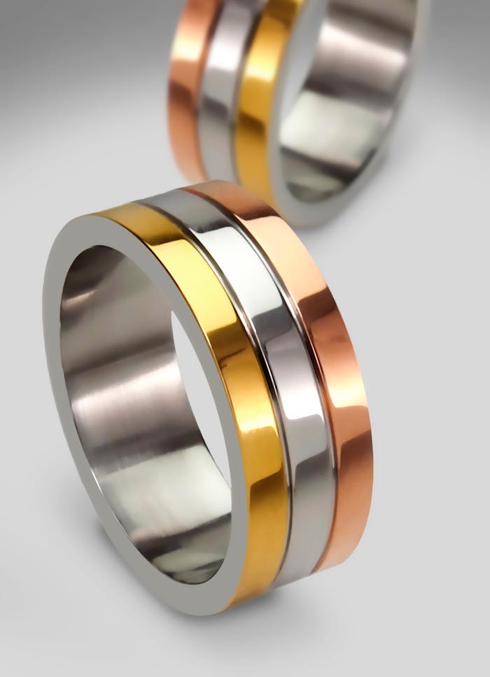 Elegant tri-color gold rings showcasing modern design, perfect for engagements or weddings.